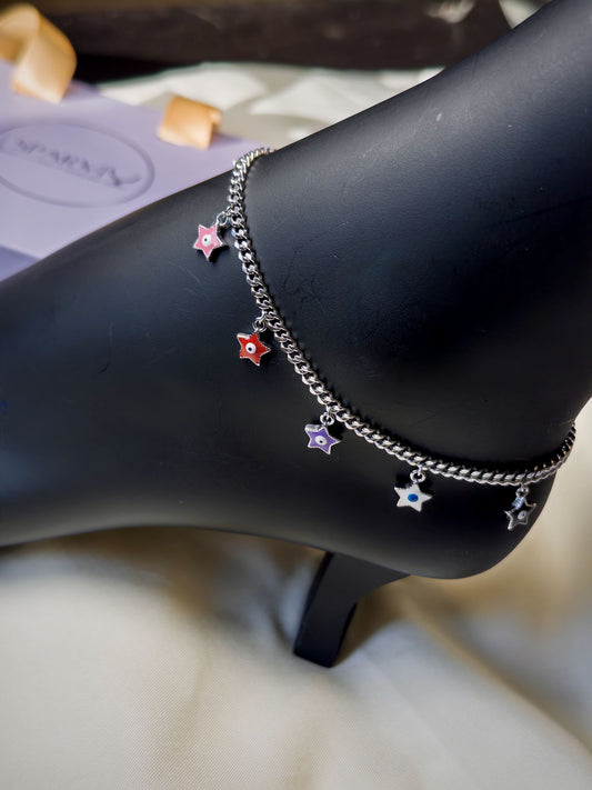 Bracelet with star-shaped charms on a black arm against a blurred background
