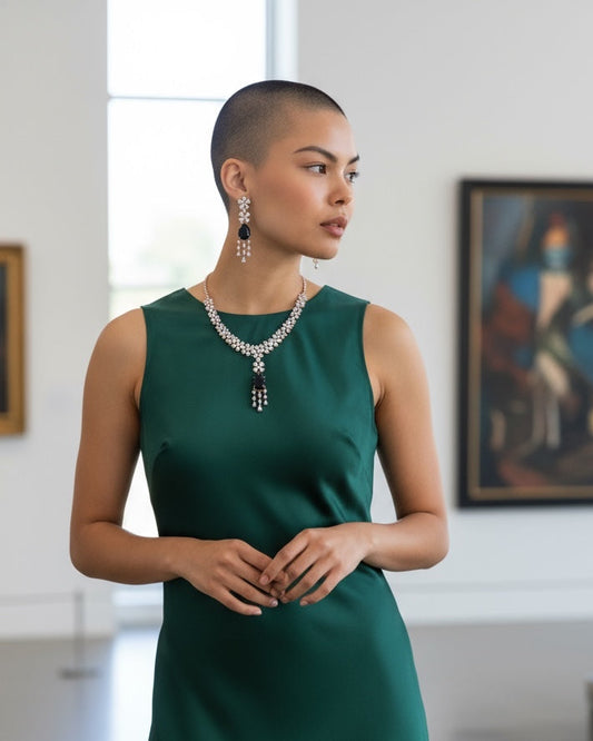 Woman in a green dress wearing Bridal Jewelry Set standing in an art gallery