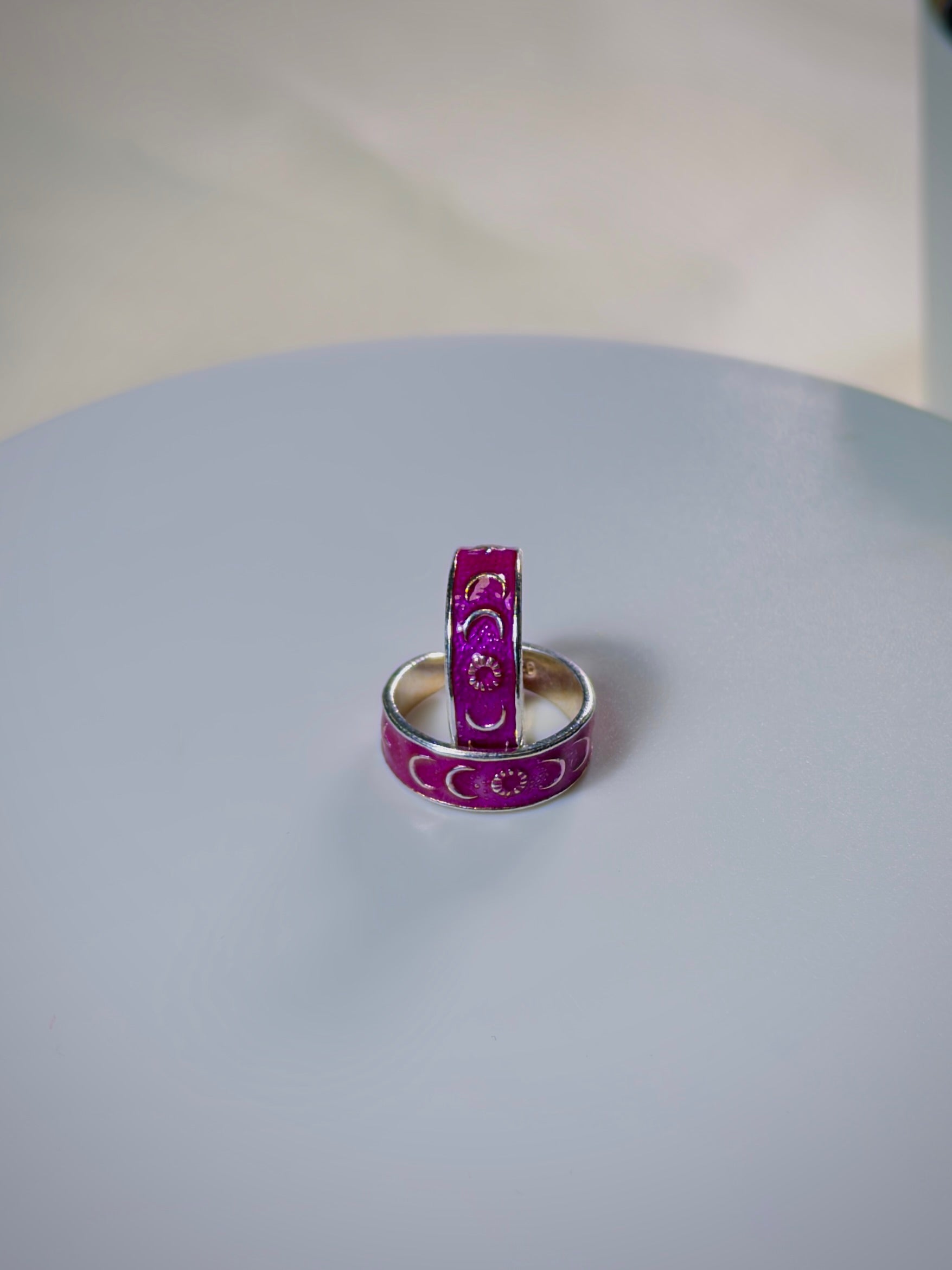 Two pinks toe rings on a light gray surface