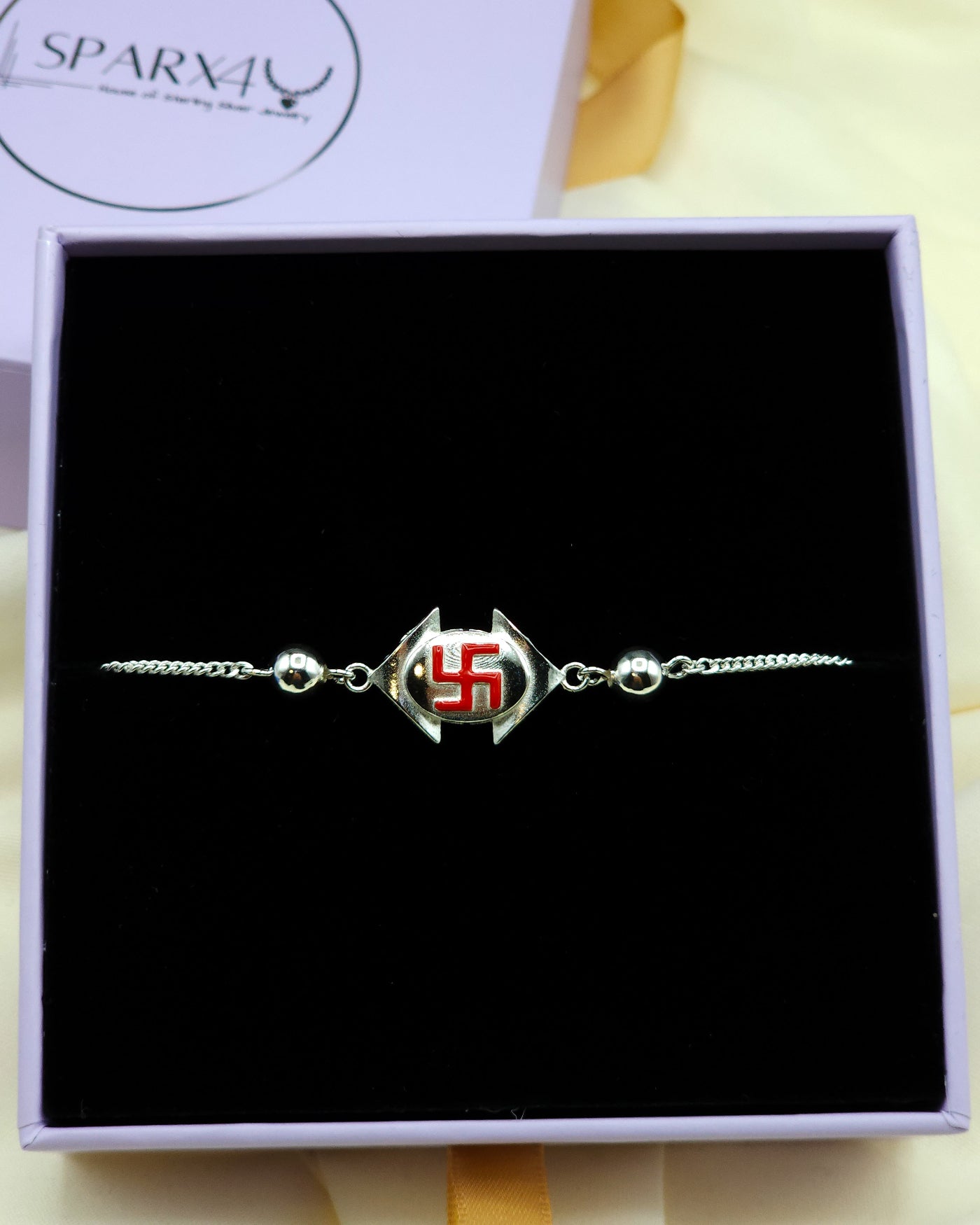 Bracelet with a red Swastika symbol in a box.