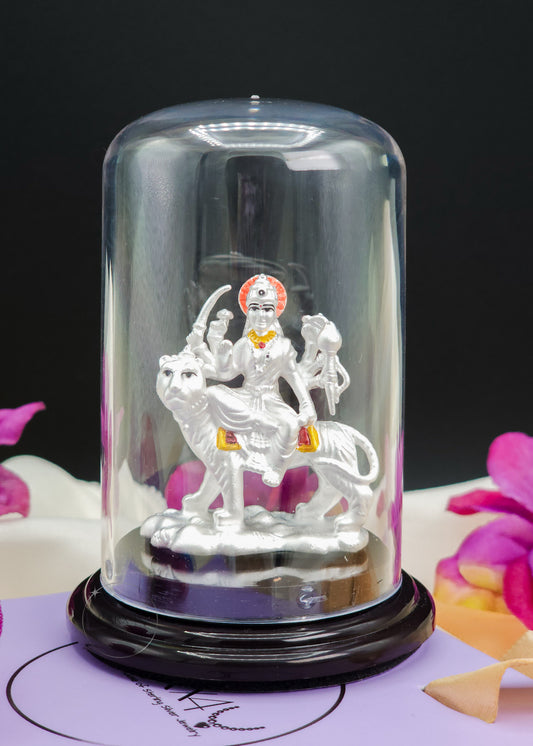 Silver Ambe Mata Idol inside a glass dome on a black background