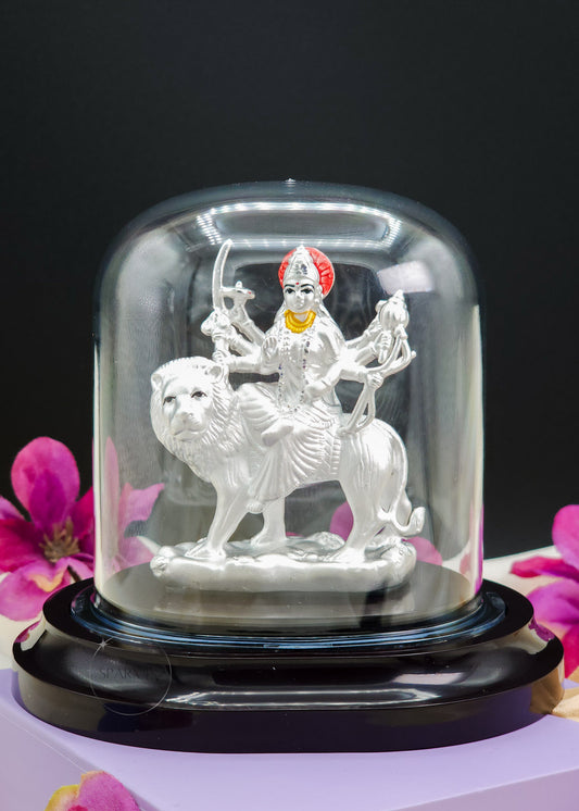 Durga Mata Idol inside a glass dome with flowers in the background