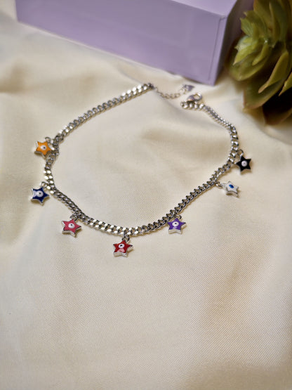 Silver bracelet with colorful star charms on a beige surface