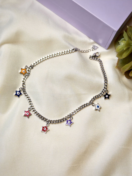Silver bracelet with colorful star charms on a beige fabric background