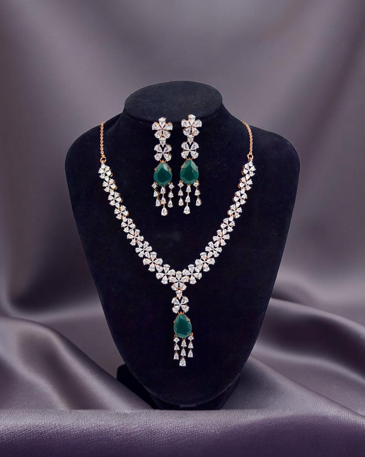Bridal Jewelry set with necklace and earrings on a black velvet stand against a gray background