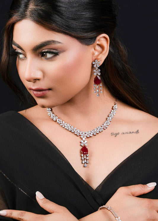 Woman wearing a black saree with bridal jewelry on a dark background