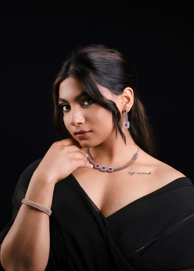 Women dressed in black saree wearing Manikya bridal jewelry set