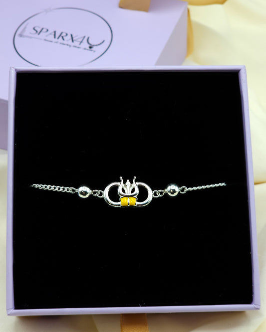 Silver bracelet with a yellow Trishool charm in a black box