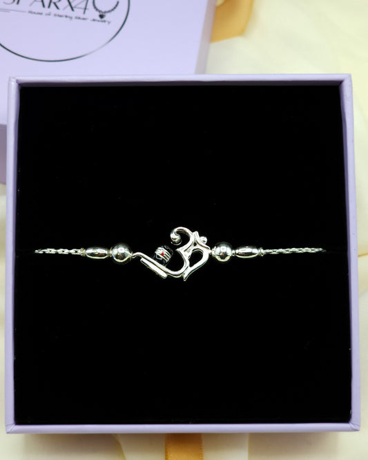 Silver bracelet with a unique Om charm in a black box.