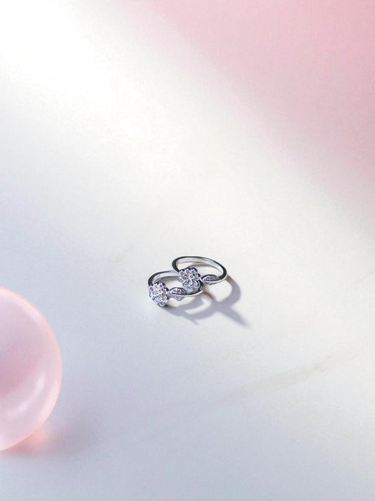 Two toe rings on a gradient pink to white background