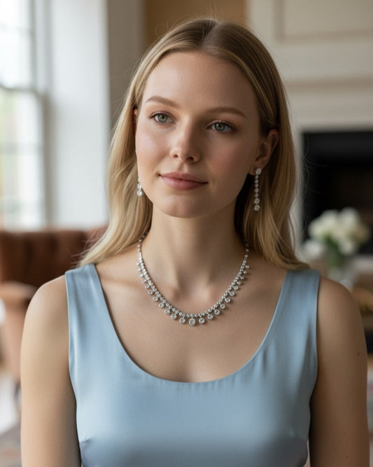 Woman wearing a light blue dress and bridal necklace indoors